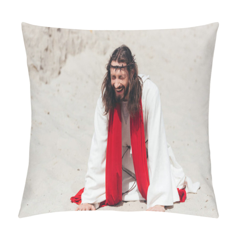 Personality  Laughing Jesus In Robe, Red Sash And Crown Of Thorns Standing On Knees And Touching Sand With Hands In Desert Pillow Covers