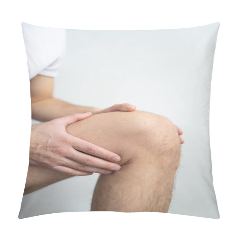 Personality  Young Man Suffering From Knee Pain On Light Background. Health Care Concept Pillow Covers