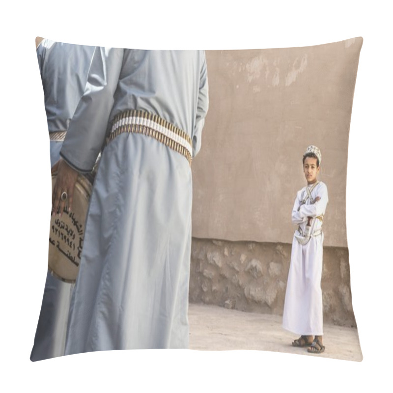 Personality  Nizwa, Oman, December 1st, 2017: omani boy looking at men celebrating a national day pillow covers