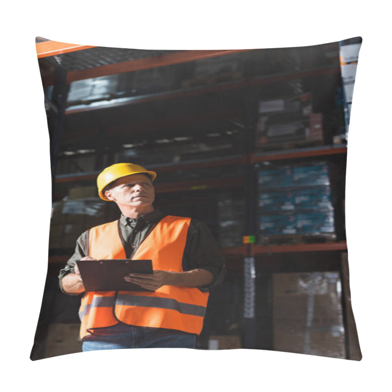 Personality  Focused Middle Aged Warehouse Supervisor In Hard Hat With Clipboard Looking At Cargo On Shelves Pillow Covers