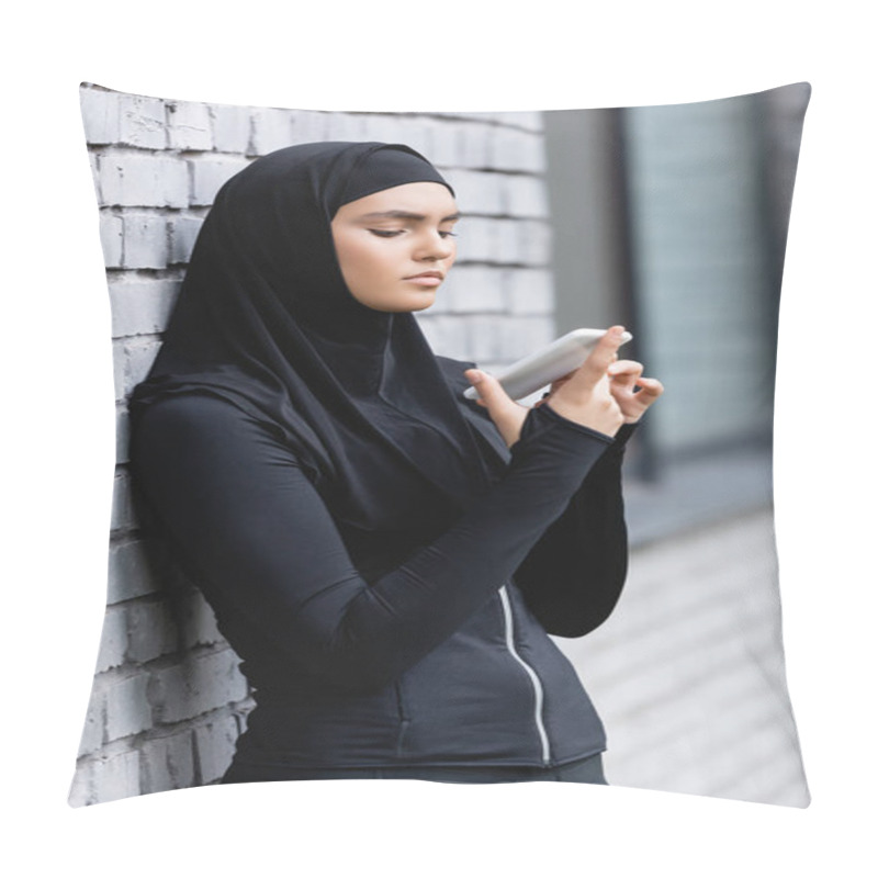 Personality  Young Muslim Woman Using Smartphone And Standing Near Brick Wall Pillow Covers