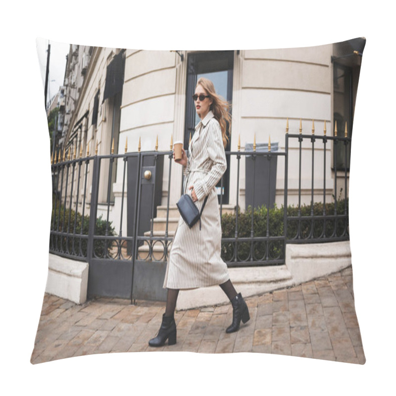 Personality  Young Pensive Woman In Striped Trench Coat And Sunglasses With Little Black Cross Bag Holding Coffee To Go In Hand Thoughtfully Looking In Camera Walking Around Cozy City Street Pillow Covers