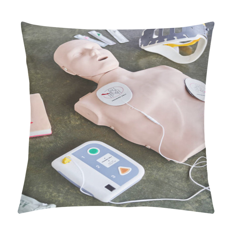 Personality  High Angle View Of CPR Manikin, External Defibrillator, Wound Care Simulator, Neck Brace And Syringes On Floor In Training Room, Medical Equipment For First Aid Training And Skills Development Pillow Covers