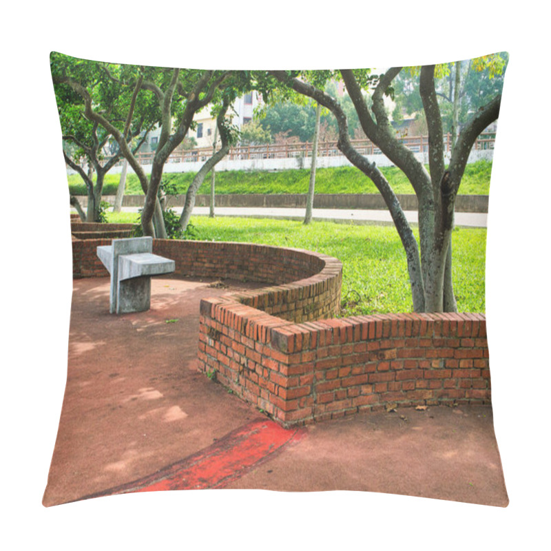 Personality  Curved Brick Benches And Concrete Seats Rest Under The Shade Of Leafy Trees On A Red-paved Surface Surrounded By Lush Green Grass. Pillow Covers