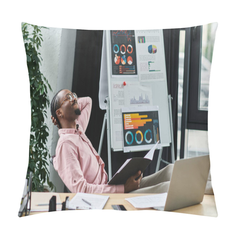 Personality  A Young African American Man Relaxes While Reviewing Charts And Data In A Stylish Workspace. Pillow Covers