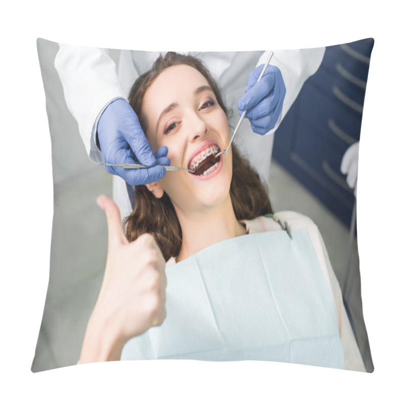 Personality  Cropped View Of Dentist In Latex Gloves Examining Attractive Woman In Braces With Opened Mouth Showing Thumb Up  Pillow Covers