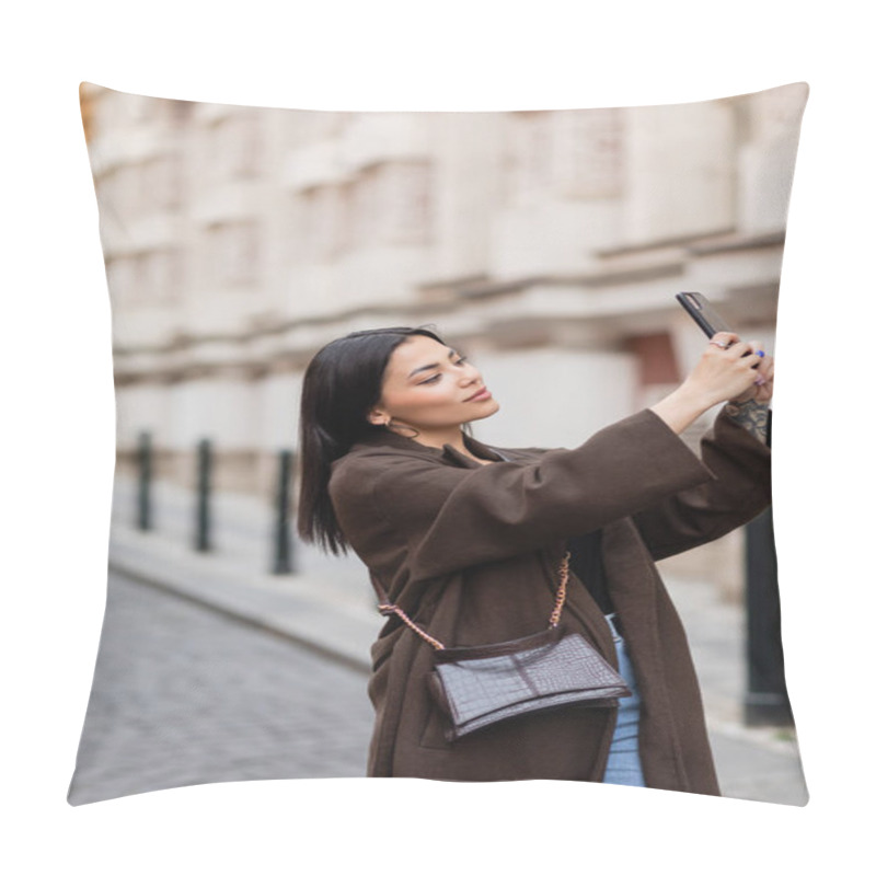 Personality  pretty young woman in brown coat taking selfie in prague on blurred background pillow covers