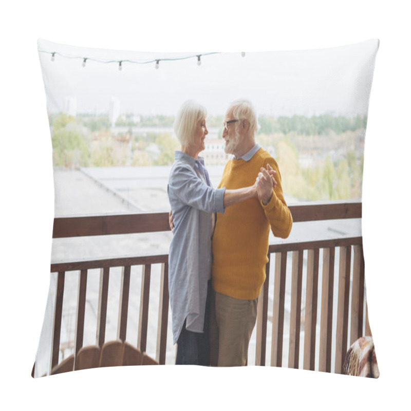 Personality  Happy Senior Couple Looking At Each Other While Dancing On Terrace On Blurred Background Pillow Covers