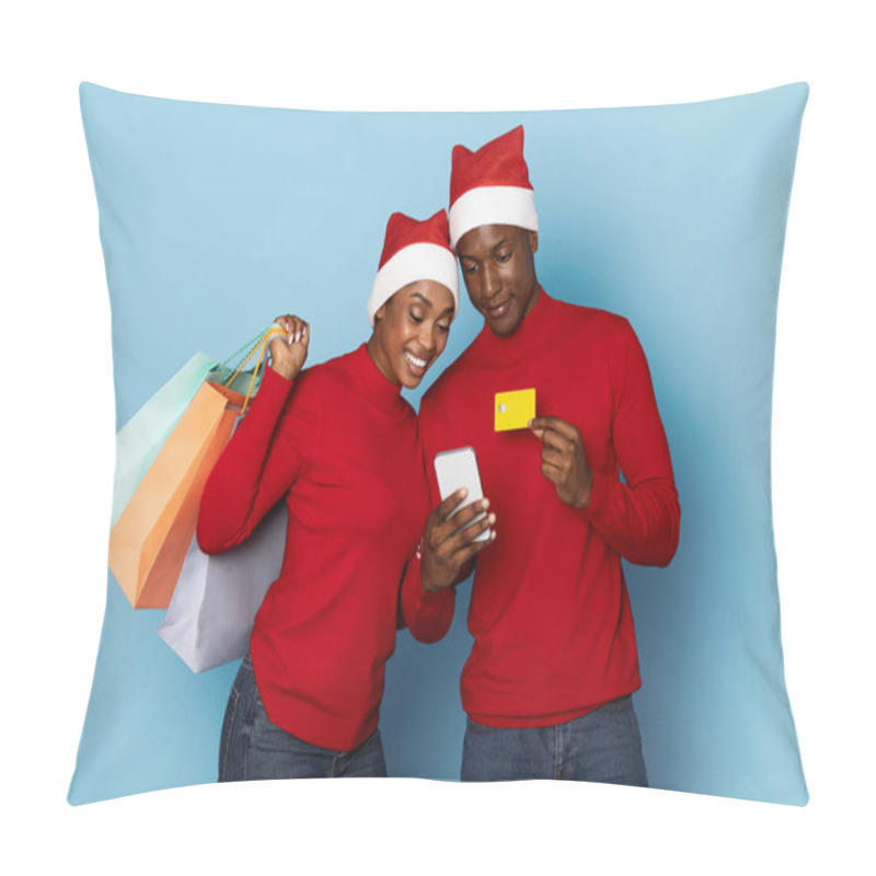 Personality  A Happy Black Couple Dressed In Matching Red Attire And Festive Hats Is Looking At A Smartphone While Holding Shopping Bags. They Are Enjoying Their Holiday Shopping Experience Together. Pillow Covers