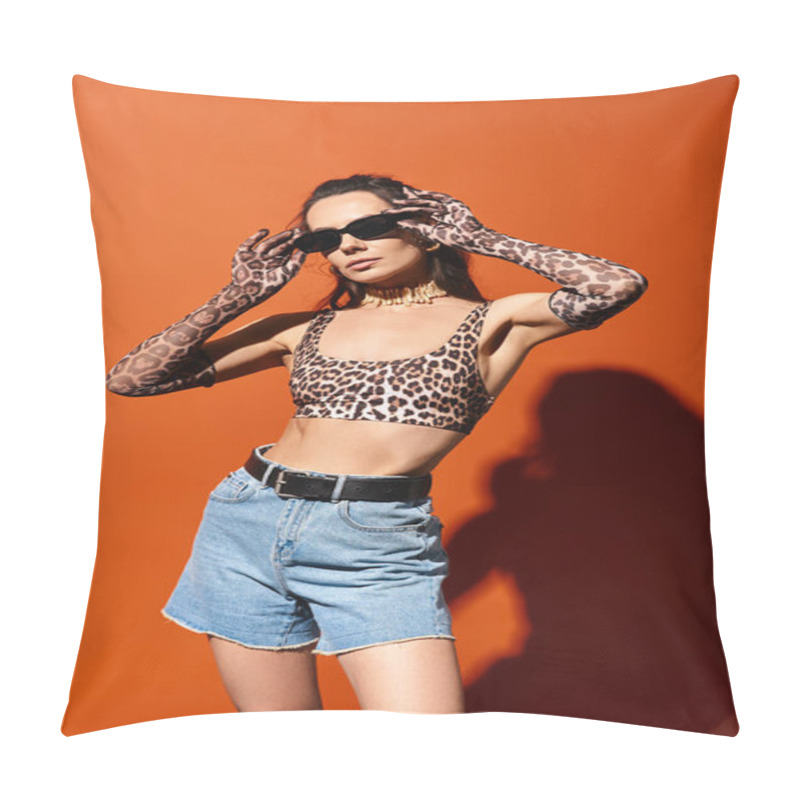 Personality  A Fashionable Woman In A Leopard Print Top And Denim Shorts Exudes Confidence In A Studio Setting Against An Orange Background. Pillow Covers