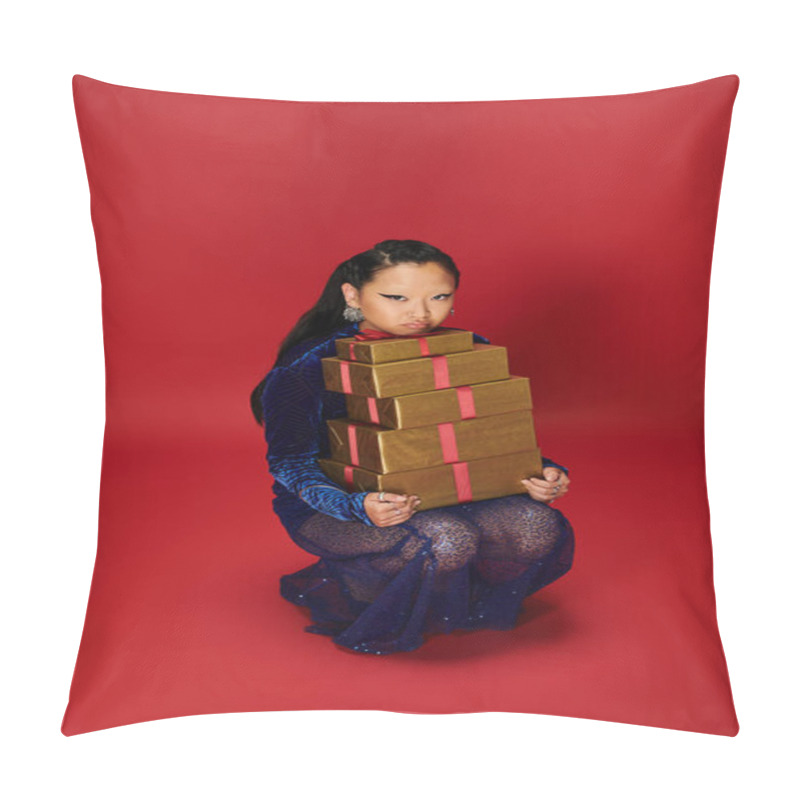 Personality  A Stylish Asian Woman Crouches Gracefully, Holding Stacked Presents Against A Vivid Backdrop. Pillow Covers