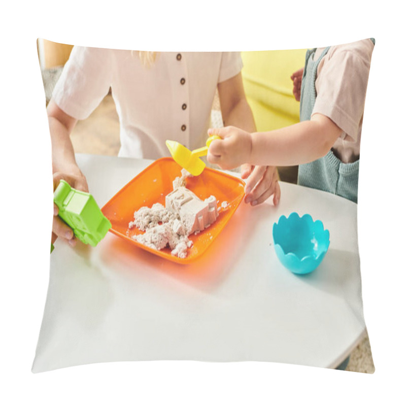 Personality  A Toddler Girl Joyfully Explores A Plate Of Sand While Her Mother Watches Closely In A Montessori-style Learning Activity. Pillow Covers