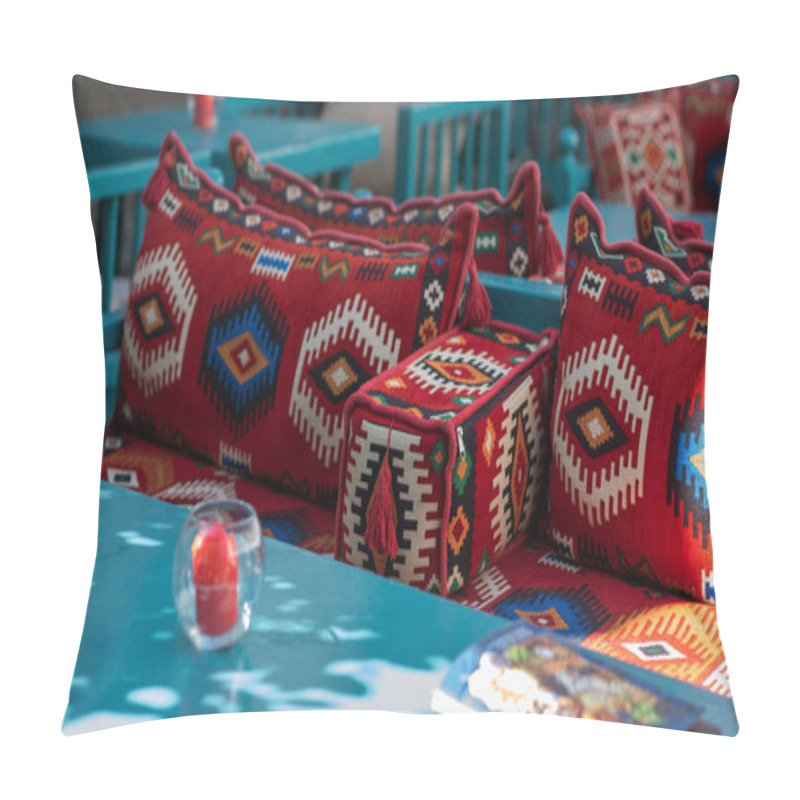 Personality  Brightly Patterned Red Cushions With Traditional Geometric Designs Adorn Turquoise Wooden Benches, With A Glass Candle Holder And Soft Natural Light In An Outdoor Seating Area. Pillow Covers