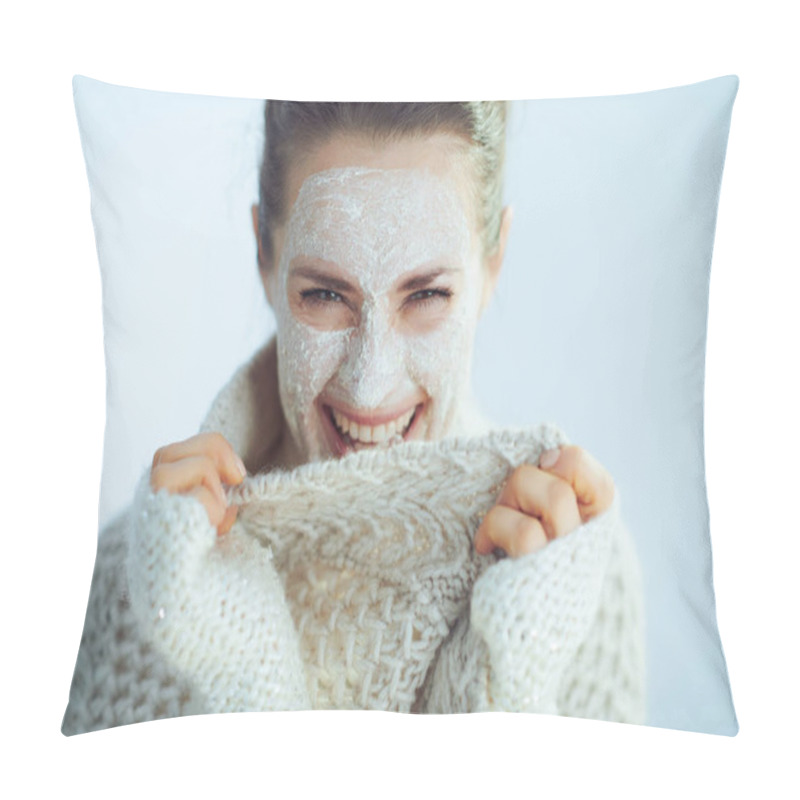 Personality  Happy Modern Woman In Roll Neck Sweater And Cardigan With White Facial Mask As Part Of Winter Skin Care Playing With Clothes On Winter Light Blue Background. Pillow Covers