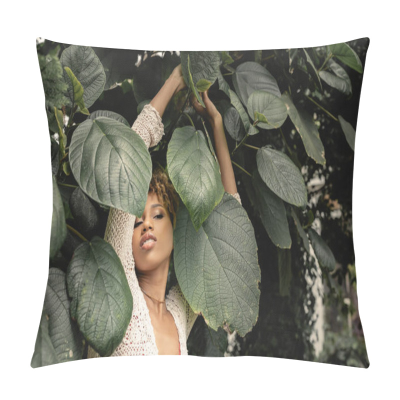 Personality  Trendy And Modern African American Woman In Summer Knitted Top Looking Away While Standing Near Green Plants In Blurred Indoor Garden, Fashion-forward Lady In Tropical Oasis Pillow Covers