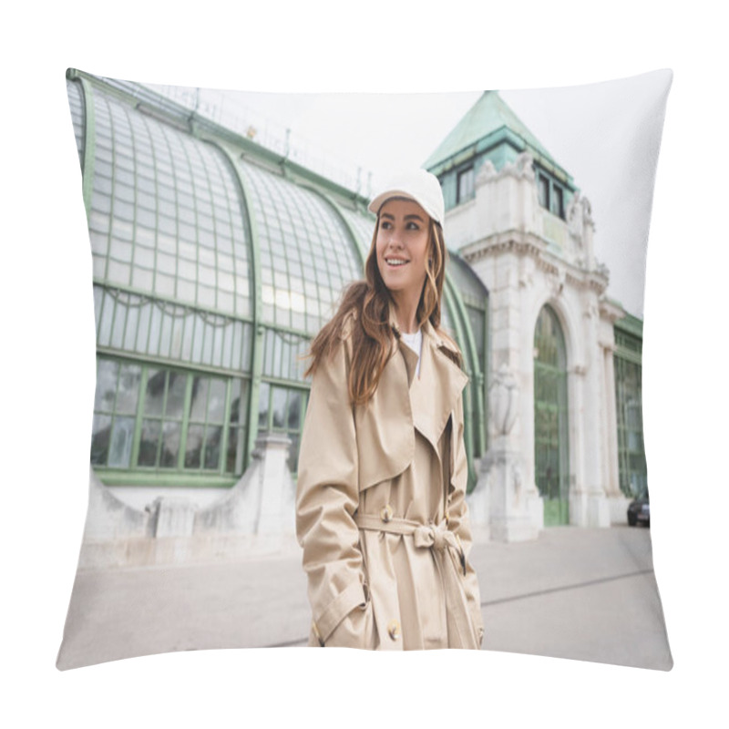 Personality  Pleased Young Woman In Trench Coat And Baseball Cap Standing With Hands In Pockets On Rooftop Pillow Covers