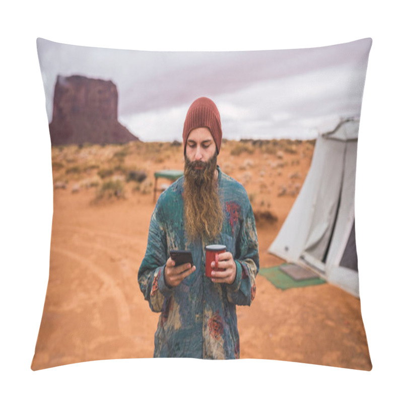 Personality  Attractive Bearded Guy With Cup Of Hot Beverage Using Modern Smartphone While Standing Not Far From Tent On Cloudy Day In Monument Valley, Utah Pillow Covers