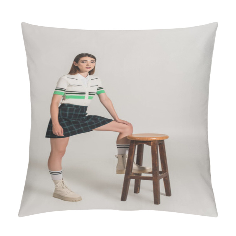 Personality  Stylish Woman In Striped Polo T-shirt, Plaid Skirt And Leather Boots Near High Stool On Grey  Pillow Covers