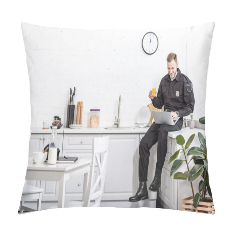 Personality  Young Policeman Sitting On Table, Drinking Orange Juice And Using Laptop At Kitchen Pillow Covers