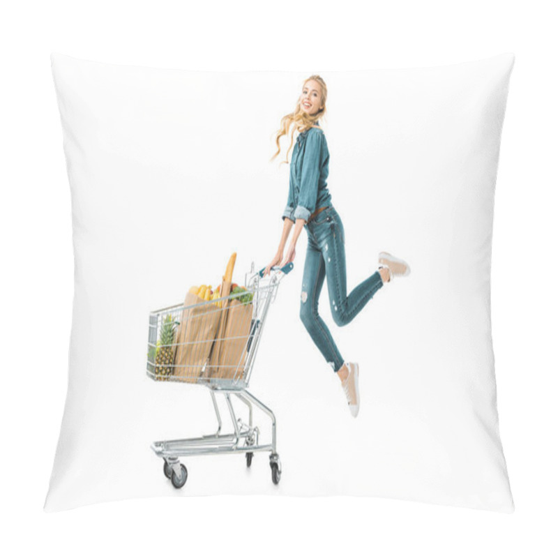 Personality  Positive Beautiful Girl Jumping Near Shopping Trolley Cart With Products In Paper Bags Isolated On White Pillow Covers