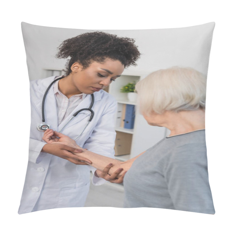 Personality  African American Traumatologist Checking Injured Arm Of Senior Patient  Pillow Covers