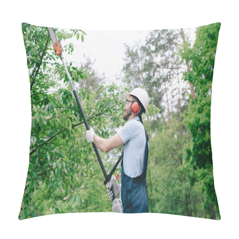 Personality  Gardener In Helmet And Overalls Trimming Trees With Telescopic Pole Saw In Garden Pillow Covers