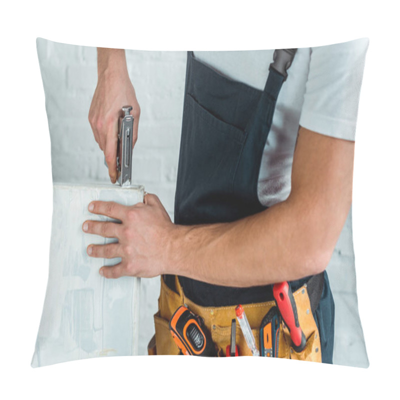 Personality  Cropped View Of Installer Holding Construction Stapler Near Painting  Pillow Covers