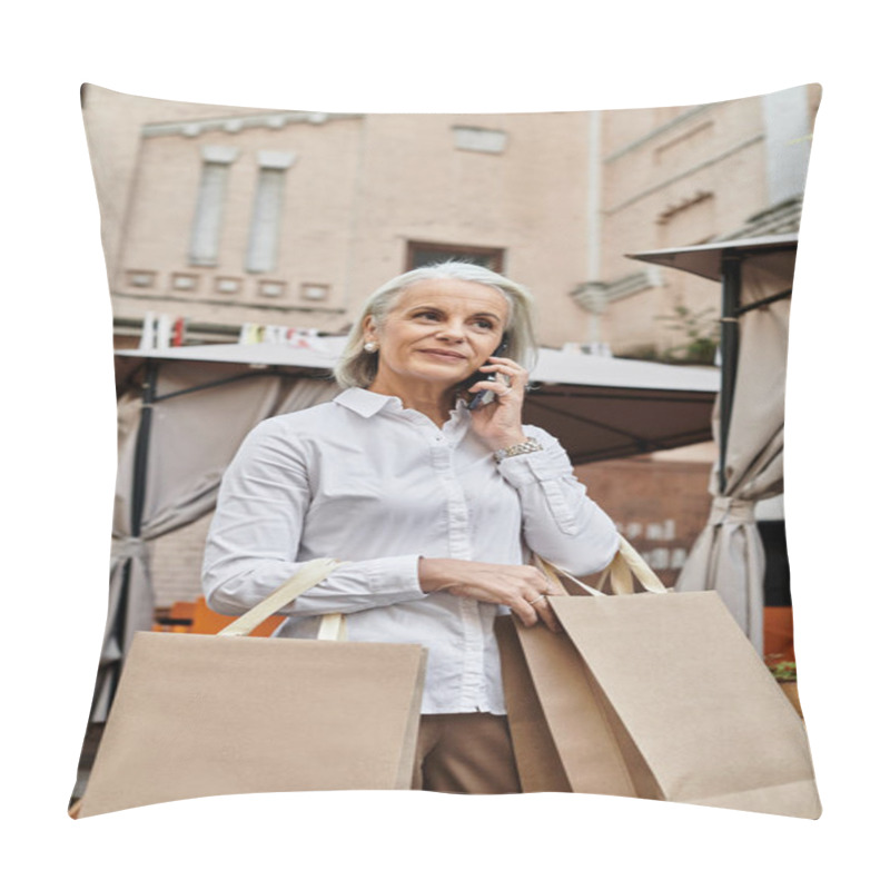 Personality  A Beautiful Older Woman With Gray Hair Carries Shopping Bags And Chats On Her Phone Outdoors. Pillow Covers