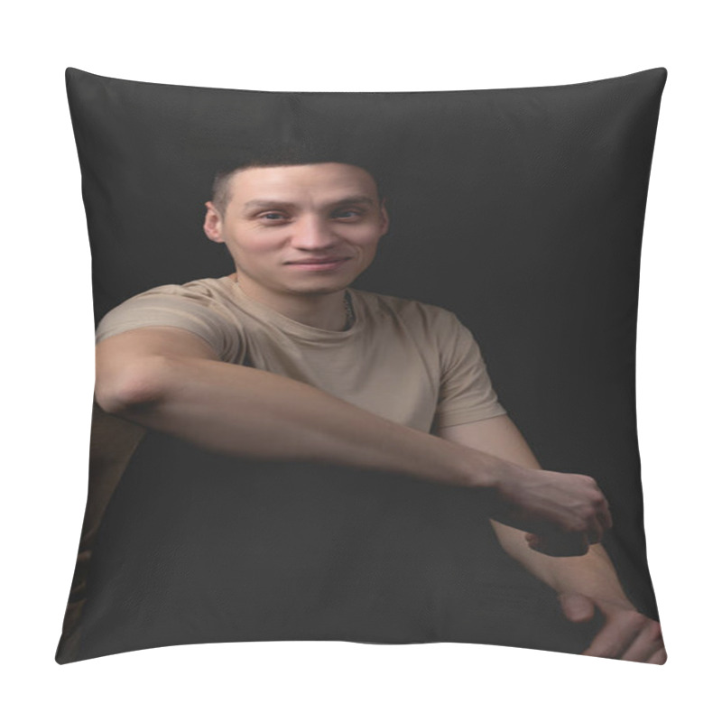 Personality  Handsome Young Man Posing Over Black Background. Studio Photo With One Light Source. Smiling Guy Cheerfully Posing In The Studio. A Cheerful Guy Sits With His Elbow On His Knee. Pillow Covers