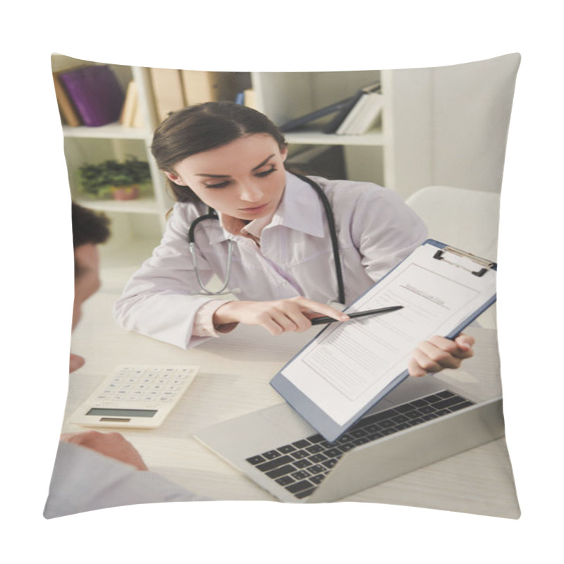 Personality  Female Doctor Showing Insurance Claim Form To Man In Office Pillow Covers