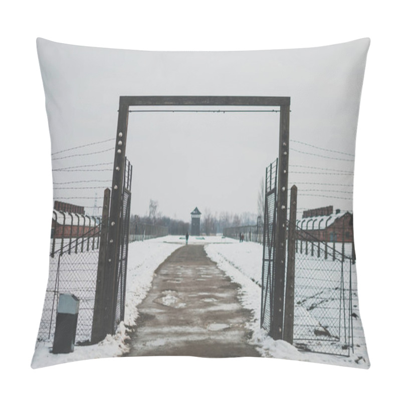 Personality  Oswiecim, Poland - February 16, 2018: One Of The Entrances To The Auschwitz Concentration Camp. Barbed Wire Fence Pillow Covers