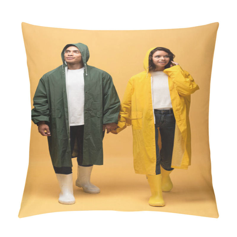 Personality  Interracial Couple In Raincoats And Rubber Boots Walking And Holding Hands On Yellow Background Pillow Covers