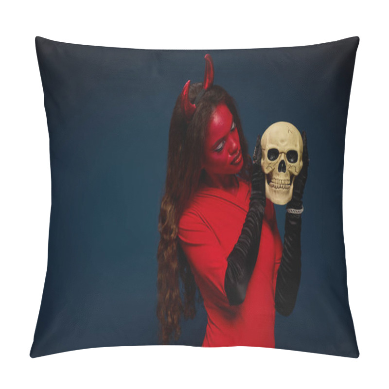 Personality  A Stunning Woman In A Devil Outfit Passionately Examines A Skull, Embracing Halloween Spirit. Pillow Covers