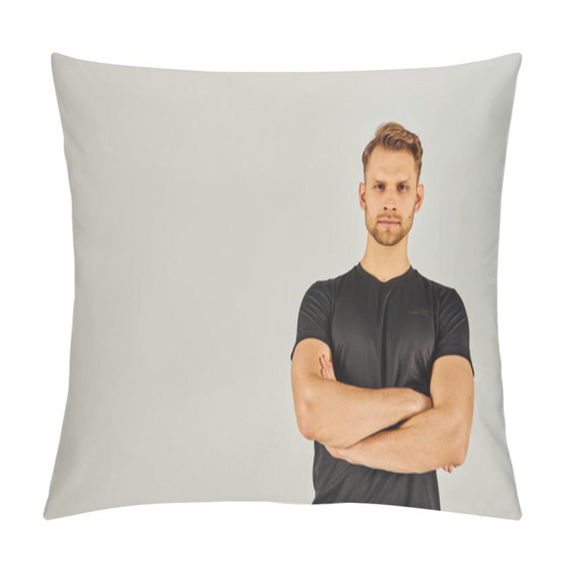 Personality  Young Athletic Man In Black T-shirt Strikes A Power Pose, Crossing His Arms In A Confident Gesture Against A Grey Studio Backdrop. Pillow Covers