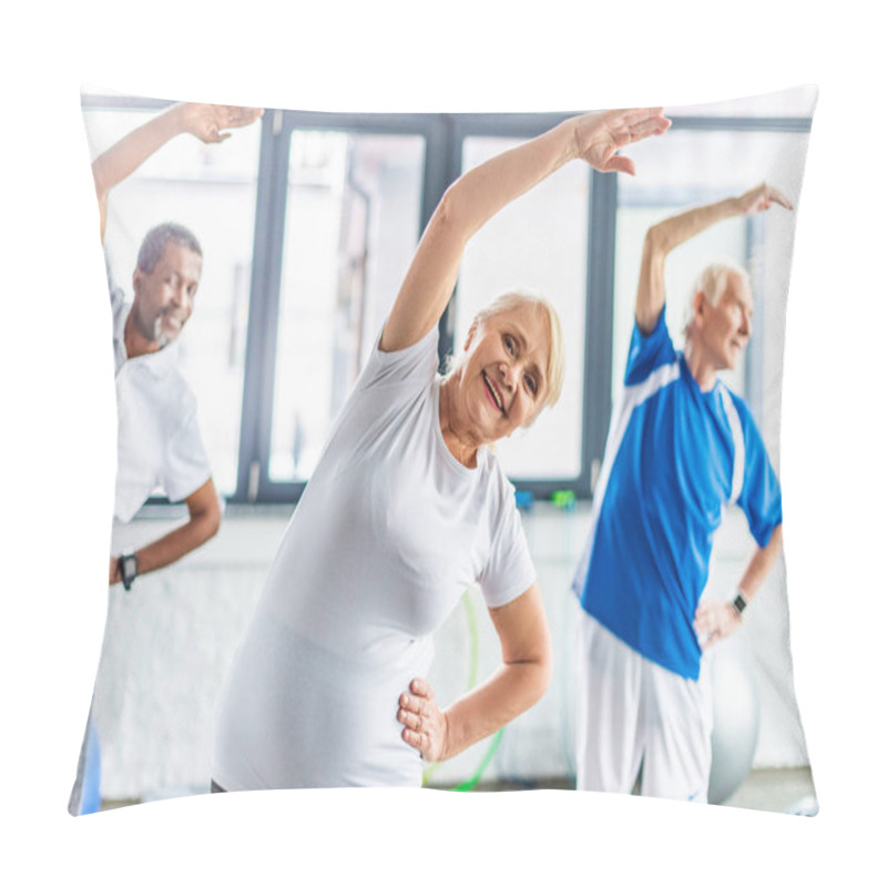 Personality  Selective Focus Of Smiling Senior Sportswoman Synchronous Exercising With Male Friends At Gym Pillow Covers