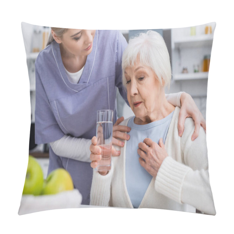 Personality  Social Worker Hugging Shoulders Of Aged Woman Holding Glass Of Water And Touching Chest, Blurred Foreground Pillow Covers