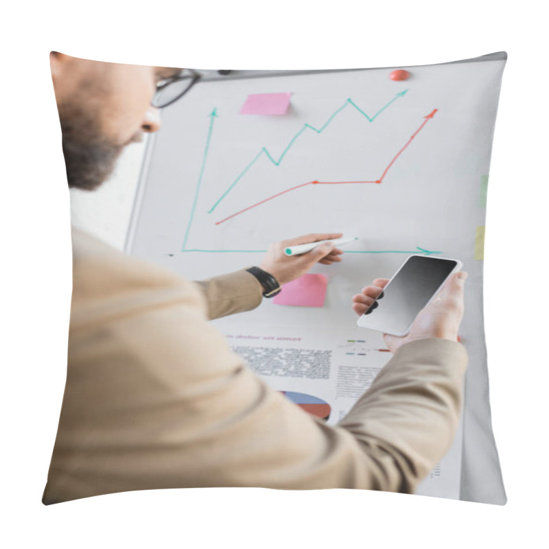 Personality  Blurred Bearded Businessman In Beige Blazer Holding Smartphone With Blank Screen While Drawing Graphs Of Market Research On Flip Chart In Modern Office Pillow Covers