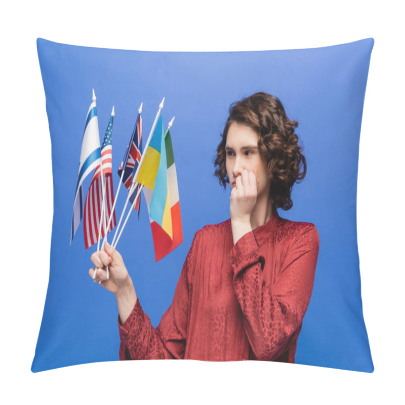 Personality  Thoughtful Woman Holding Hand Near Face While Looking At Flags Of Different Countries Isolated On Blue Pillow Covers