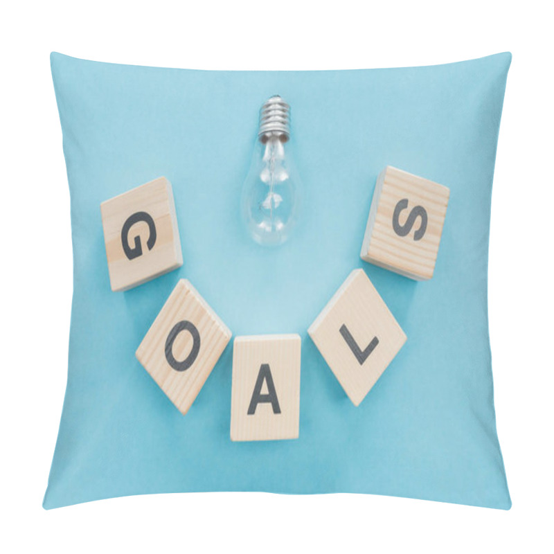 Personality  Top View Of Light Bulb Over 'goals' Word Made Of Wooden Blocks On Blue Background, Goal Setting Concept Pillow Covers