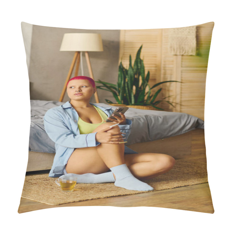 Personality  A Young Woman Sits Comfortably On The Floor, Lost In Thought While Holding Her Phone. Pillow Covers