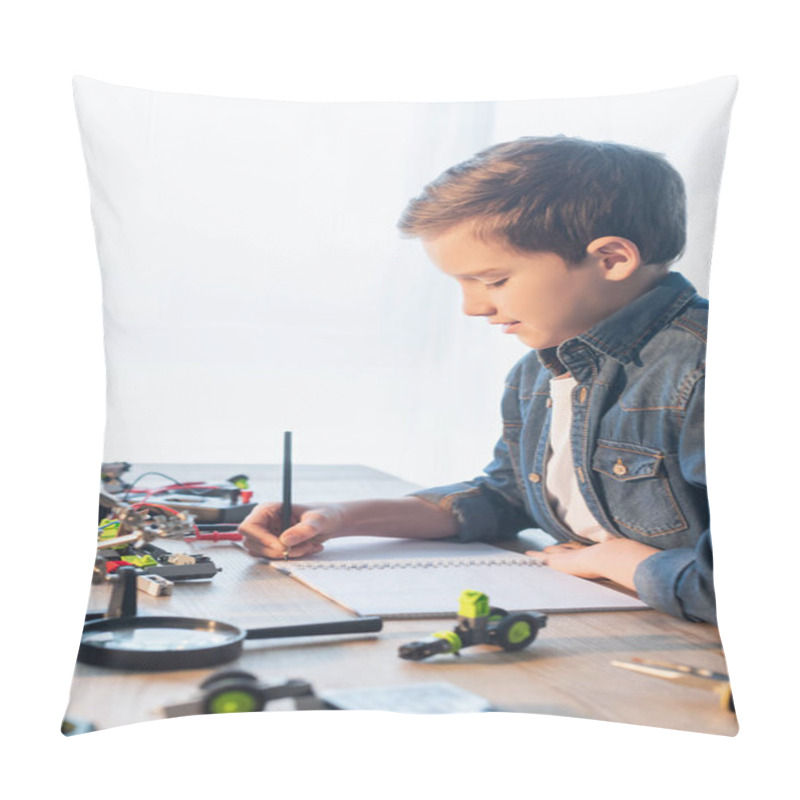 Personality  Side View Of Preteen Boy Writing On Notebook Near Magnifying Glass And Robotic Model At Home  Pillow Covers