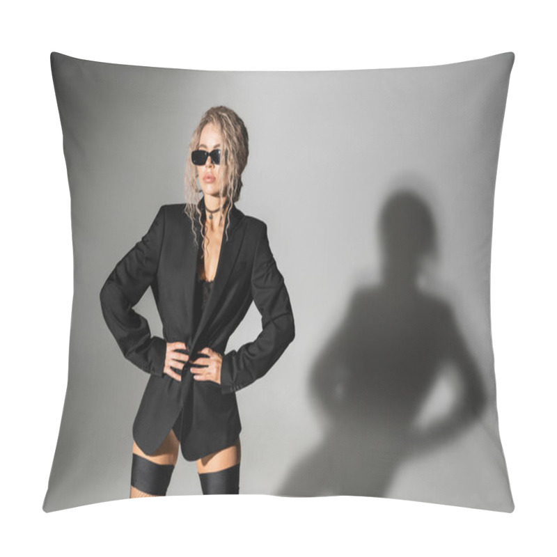 Personality  Confident And Sexy Female Model With Wavy Ash Blonde Hair Posing In Dark Sunglasses, Black Blazer And Stockings While Holding Hands On Waist And Looking Away On Grey Background Pillow Covers