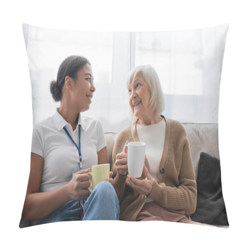 Personality  Happy Multiracial Social Worker Having Tea And Chatting With Senior Woman In Living Room  Pillow Covers