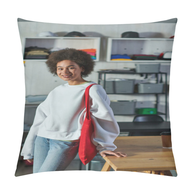 Personality  Positive Young African American Craftswoman With Shoulder Bag Looking At Camera And Standing Near Coffee To Go On Table In Print Studio, Enthusiastic Business Owner Working In Workshop Pillow Covers