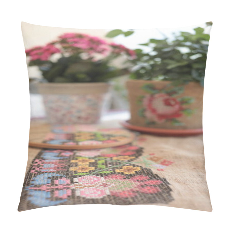 Personality  Traditional Cross Stitched Folk Motif Embroidery On Natural Burlap Fabric Background. Selective Focus To Foreground And Blurred Background With Houseplants In Flower Pots. Needlework Embroidery Hobby Pillow Covers