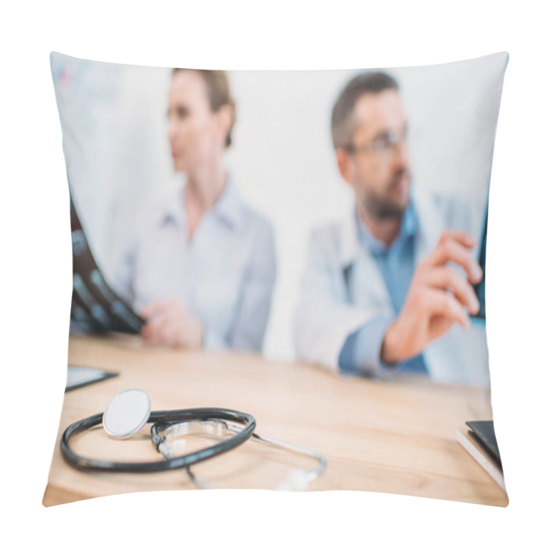 Personality  Close-up Shot Of Stethoscope On Desk With Doctors Examining X-ray Scans Blurred On Background Pillow Covers