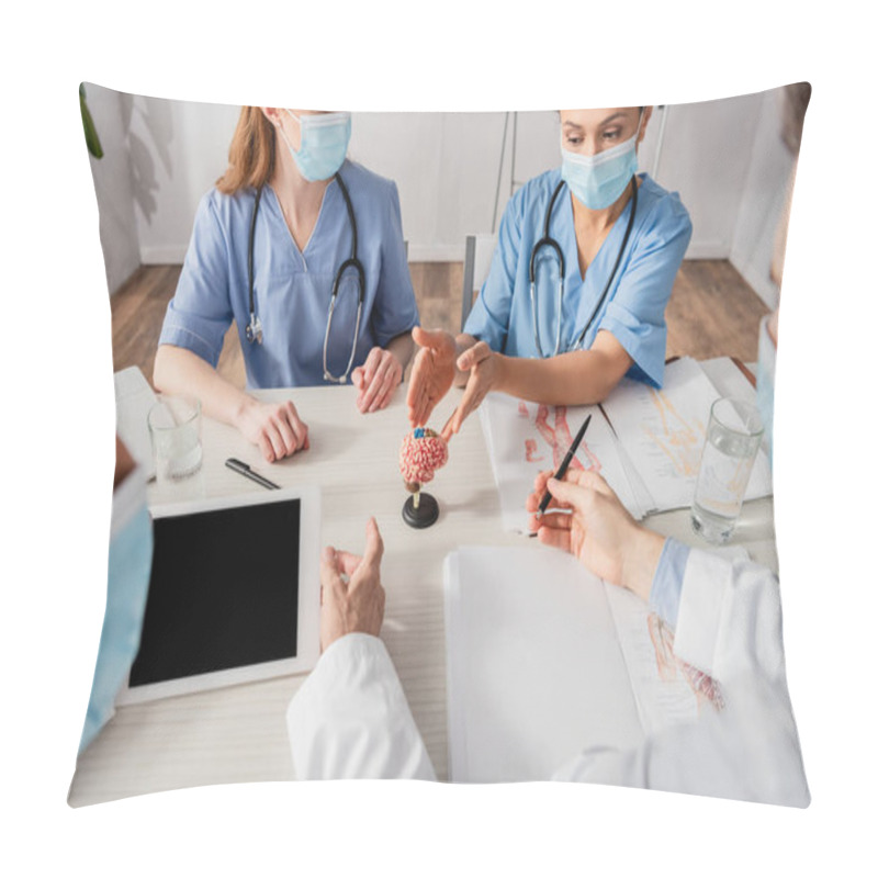 Personality  African American Nurse Pointing With Hands At Brain Anatomical Model Near Colleagues At Workplace On Blurred Foreground Pillow Covers