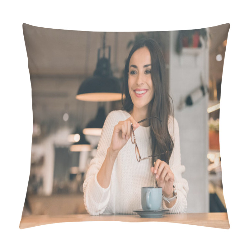 Personality  Smiling Young Woman Holding Eyeglasses While Sitting At Table With Coffee Cup In Cafe Pillow Covers