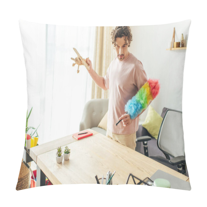 Personality  A Man In Cozy Attire Holding A Toy Airplane In A Living Room. Pillow Covers