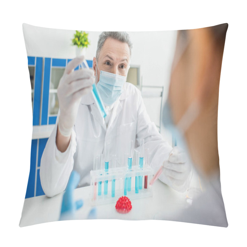 Personality  Bioengineer In Medical Mask Holding Test Tube Near Blurred Colleague And Coronavirus Bacteria Model Pillow Covers